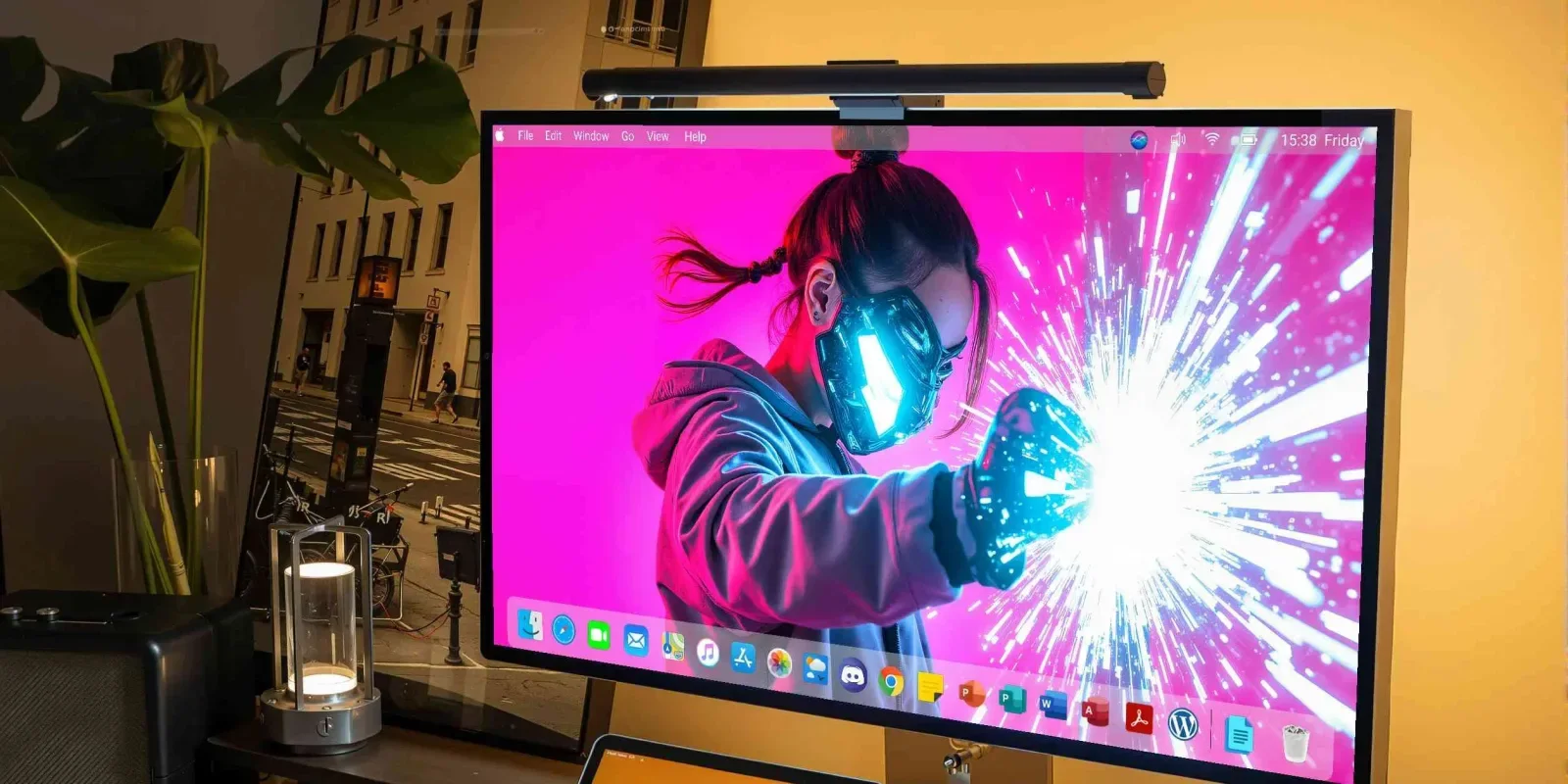 A desktop monitor shows a figure with twin tails and a bright cyan visor thrusting a gloved fist into a white burst on a magenta background.